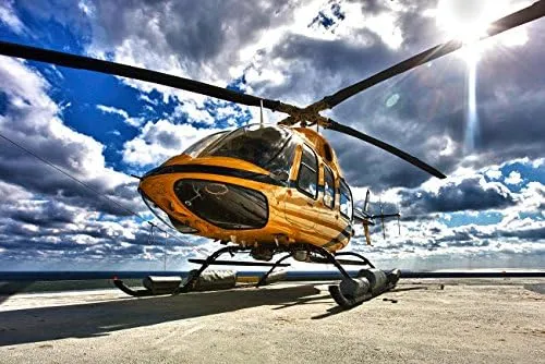 A Bell 407 utility helicopter on the helipad of an oil rig Poster Print by Terry MooreStocktrek Images (17 x 11)