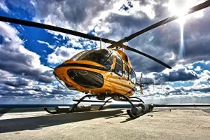 A Bell 407 utility helicopter on the helipad of an oil rig Poster Print by Terry MooreStocktrek Images (17 x 11)